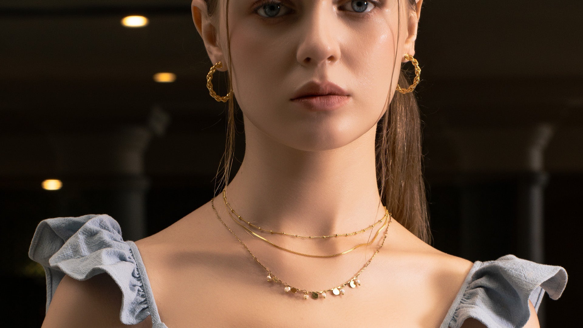LAVANA elegant gold necklace worn by model in lifestyle shot on Necklaces page