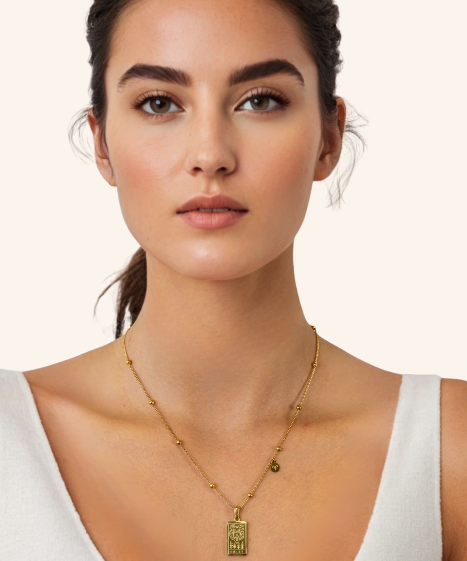 Aries Gold Zodiac Tag Necklace by Lavana, on model engraved tag front and back on beaded station chain, front