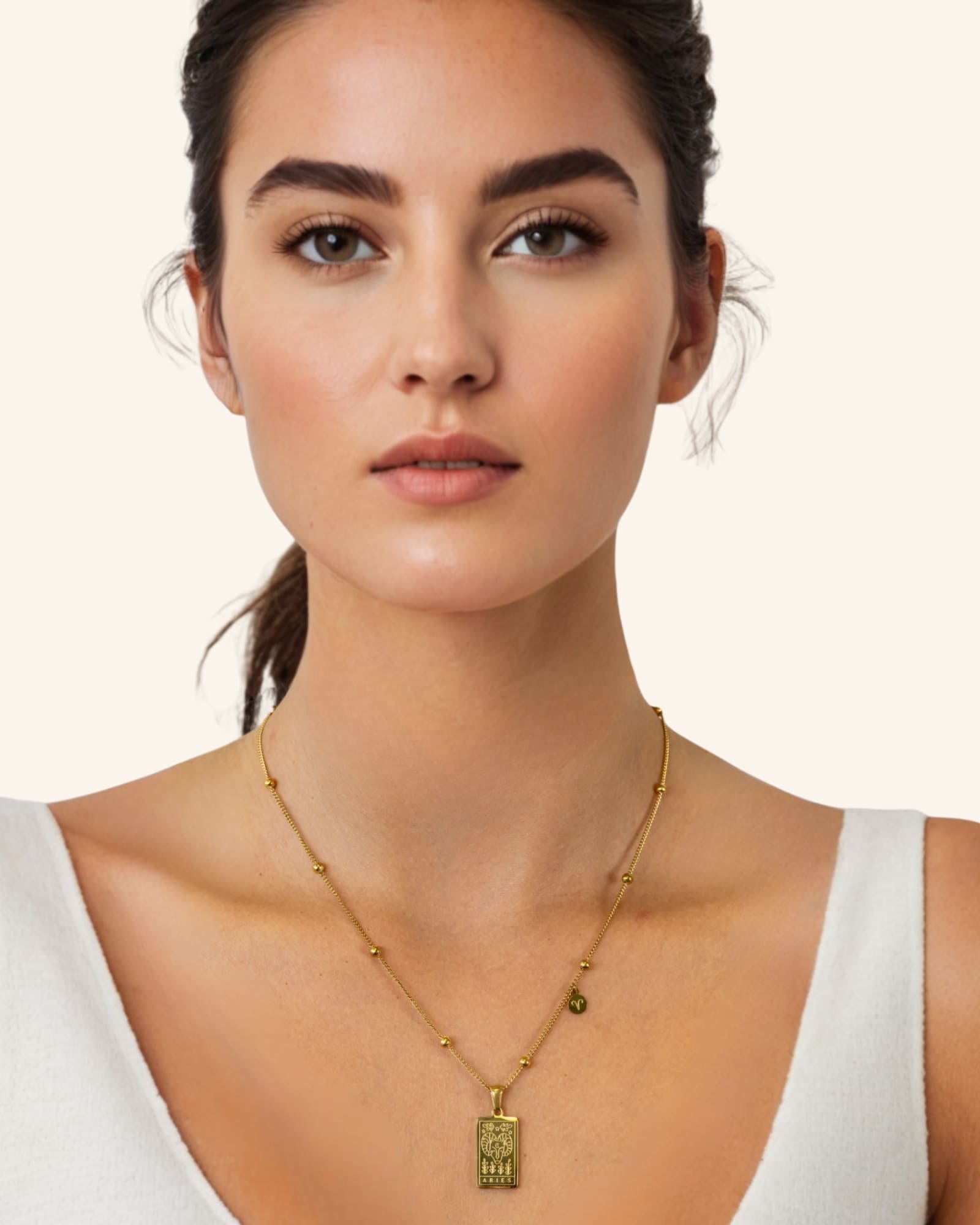 Aries Gold Zodiac Tag Necklace by Lavana, on model engraved tag front and back on beaded station chain, front