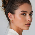 Aura Gold Hoop Earrings Small by Lavana on model with angled light catching detail