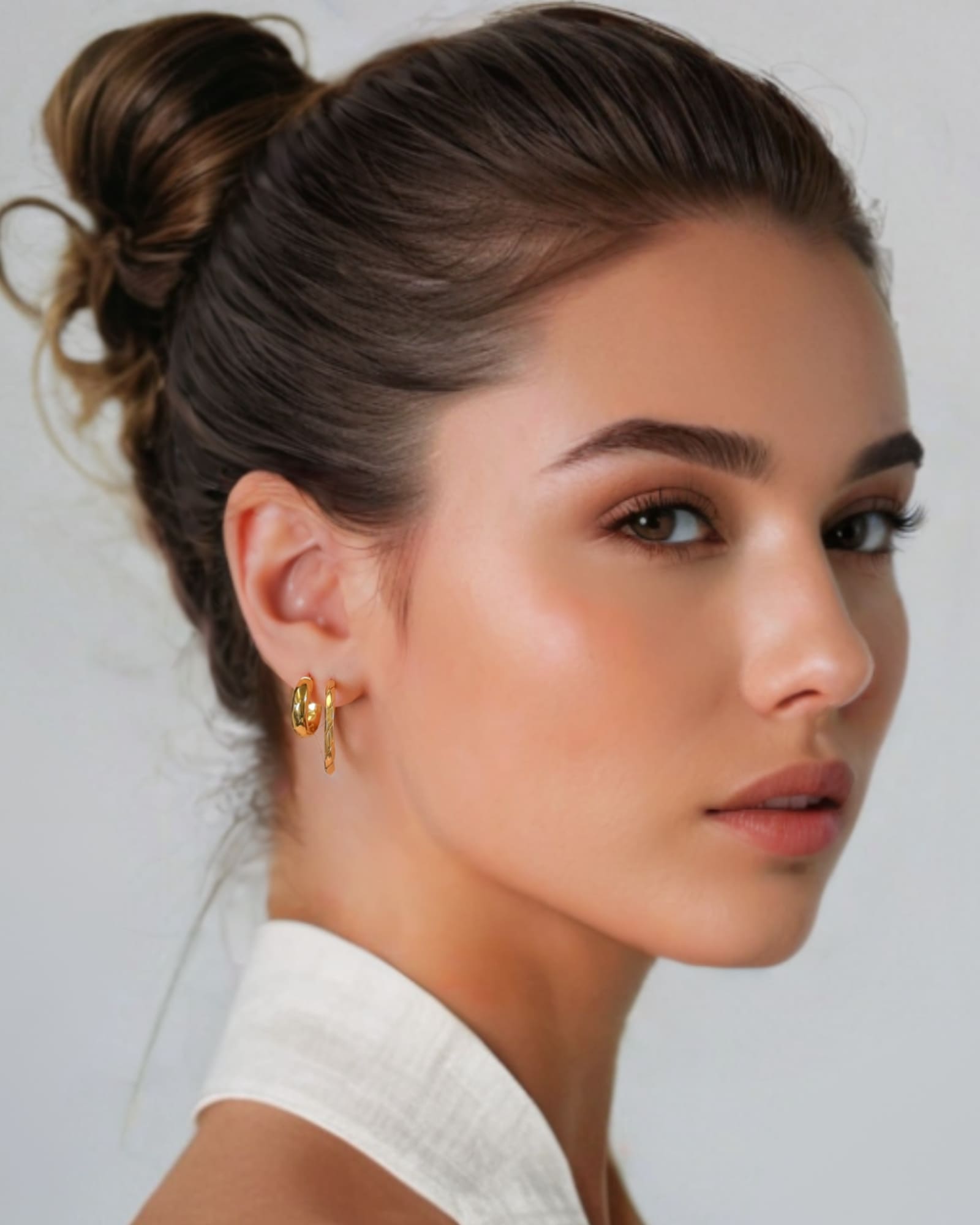 Aura Gold Hoop Earrings Small by Lavana on model with angled light catching detail