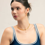 Aura Gold Hoop Earrings by LAVANA, on model; wide medium dress hoops with angled light catching detail, large