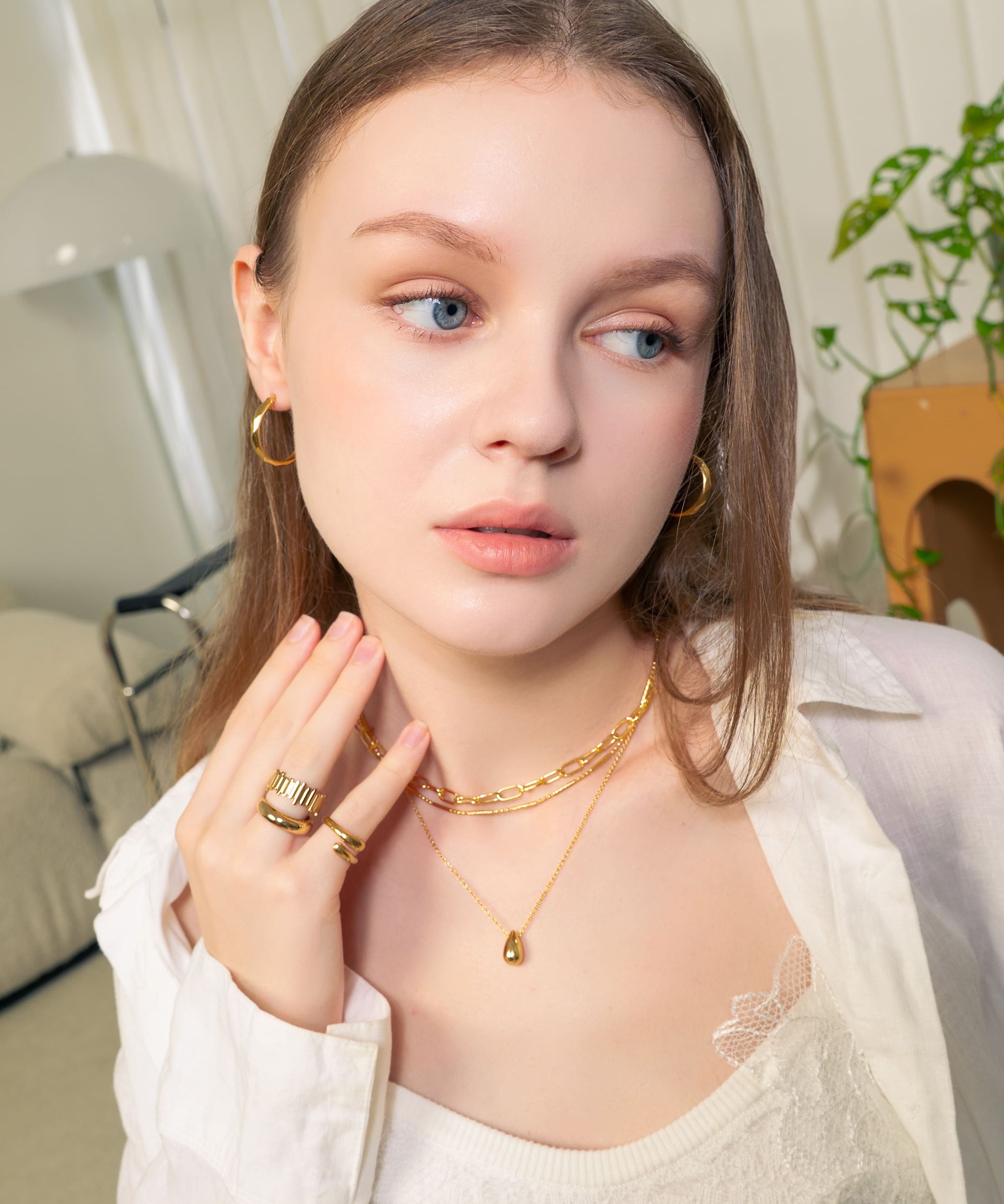 Aura Gold Hoop Earrings by LAVANA, on model wide medium dress hoops with angled light catching detail