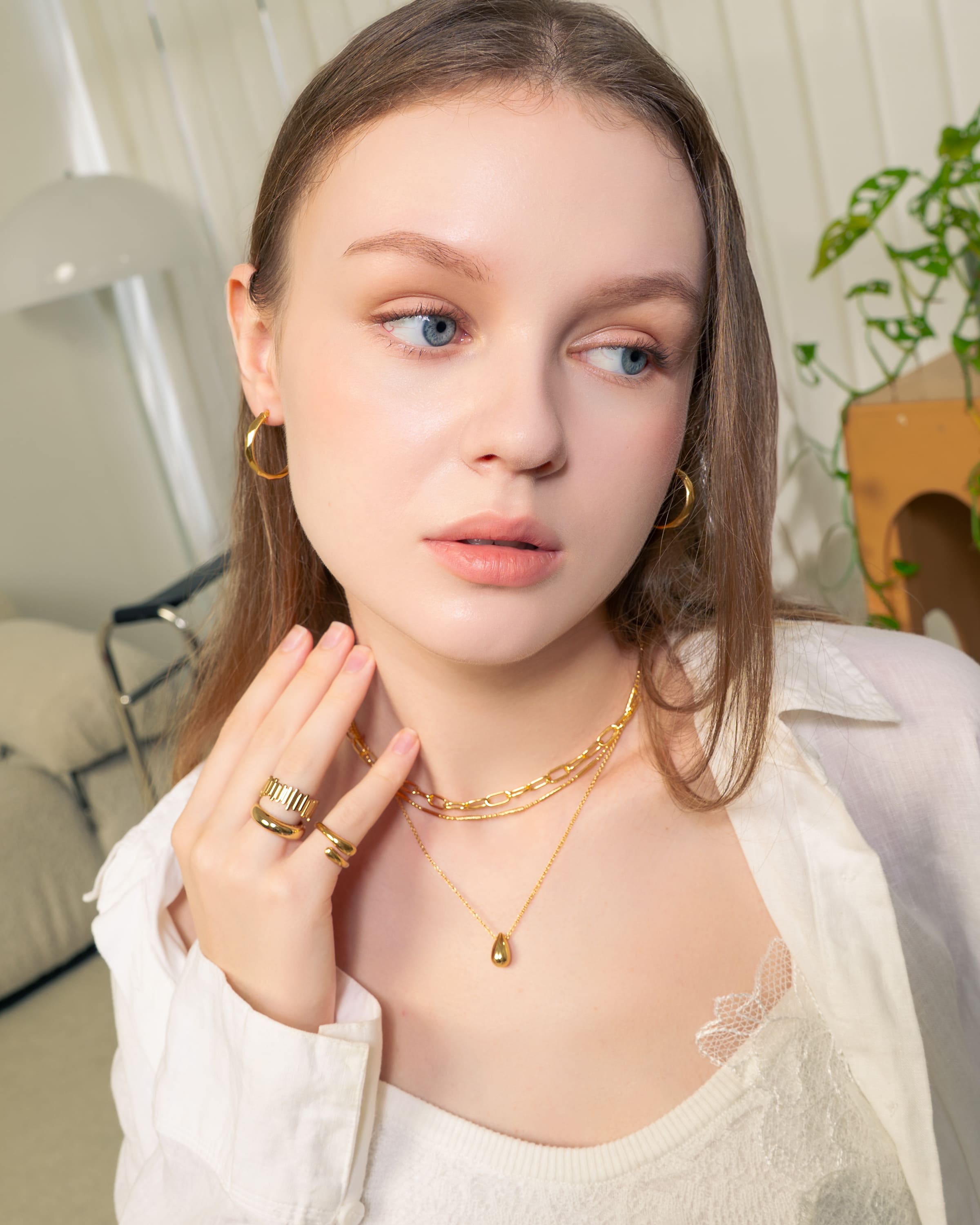 Aura Gold Hoop Earrings by LAVANA, on model wide medium dress hoops with angled light catching detail