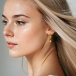 Aura Gold Hoop Earrings Large by Lavana on model wide medium hoops with angled light catching detail