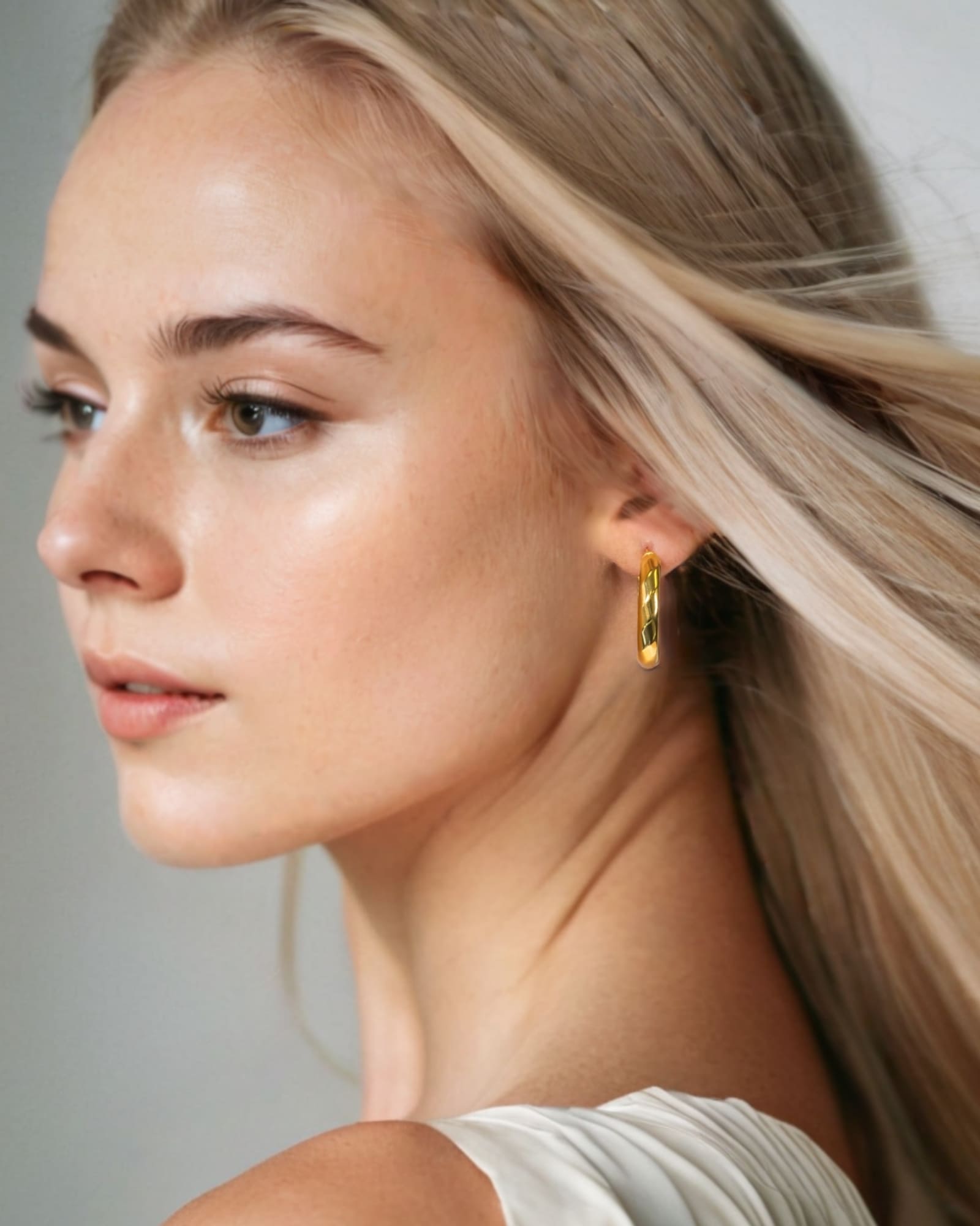 Aura Gold Hoop Earrings Large by Lavana on model wide medium hoops with angled light catching detail