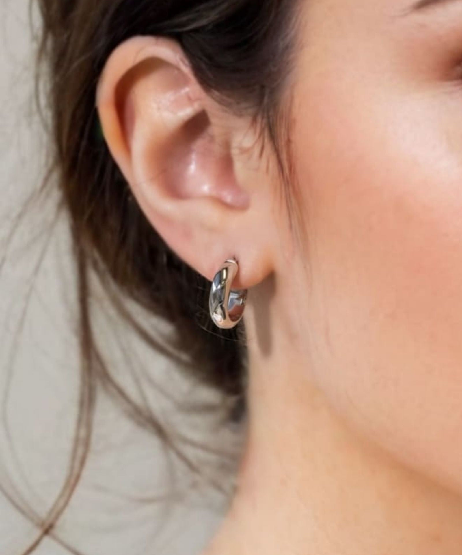 Aura Silver Hoop Earrings Small by Lavana on model wide medium hoops with angled light catching detail