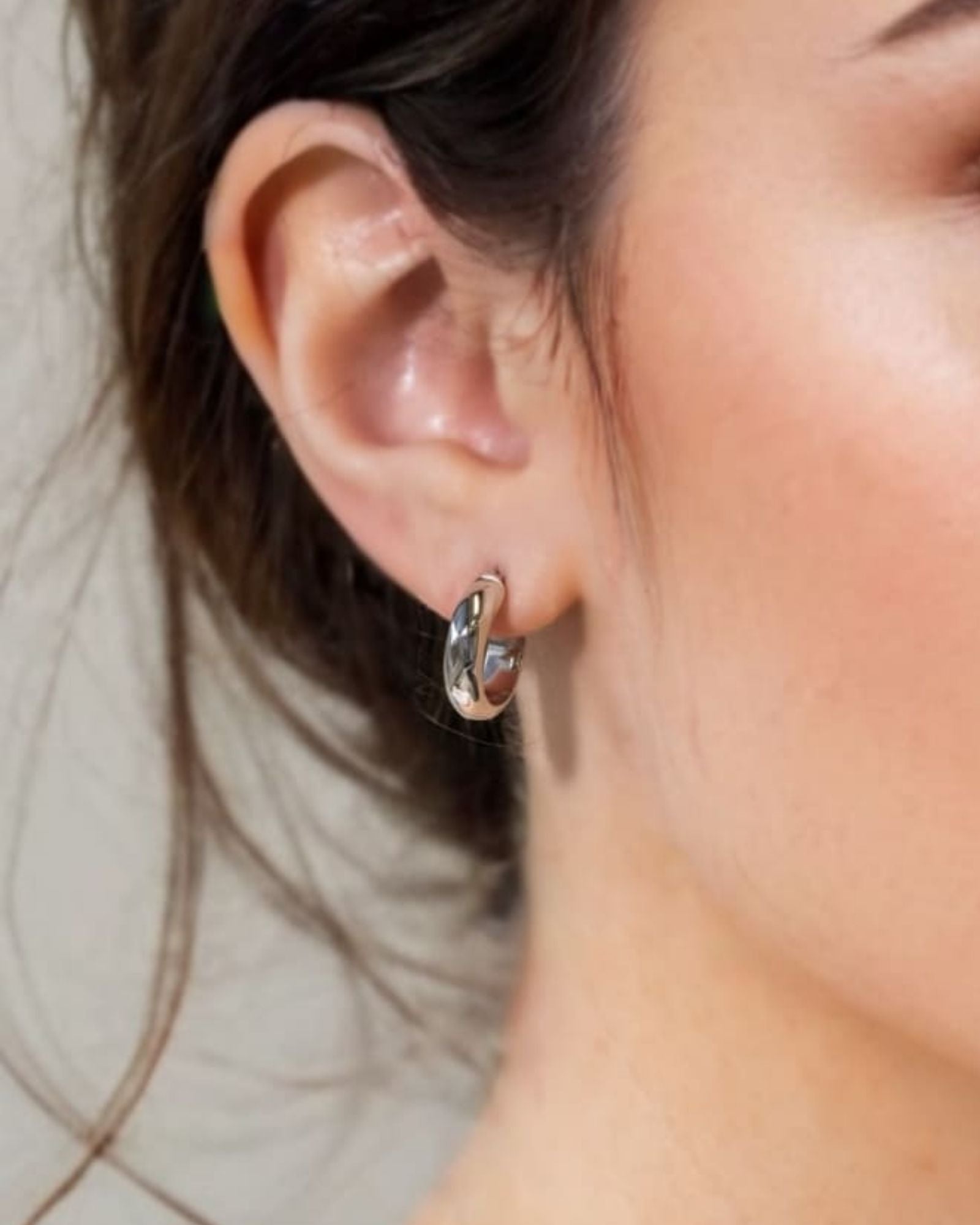 Aura Silver Hoop Earrings Small by Lavana on model wide medium hoops with angled light catching detail
