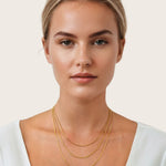 Cali Gold Snake Chain Necklace by Lavana, on model; layered sleek flat snake chain with polished finish