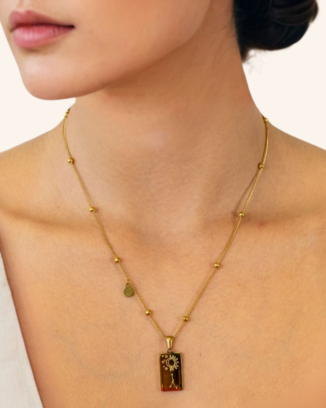 Cancer Gold Zodiac Tag Necklace by Lavana, on model engraved tag with constellation on beaded chain, back