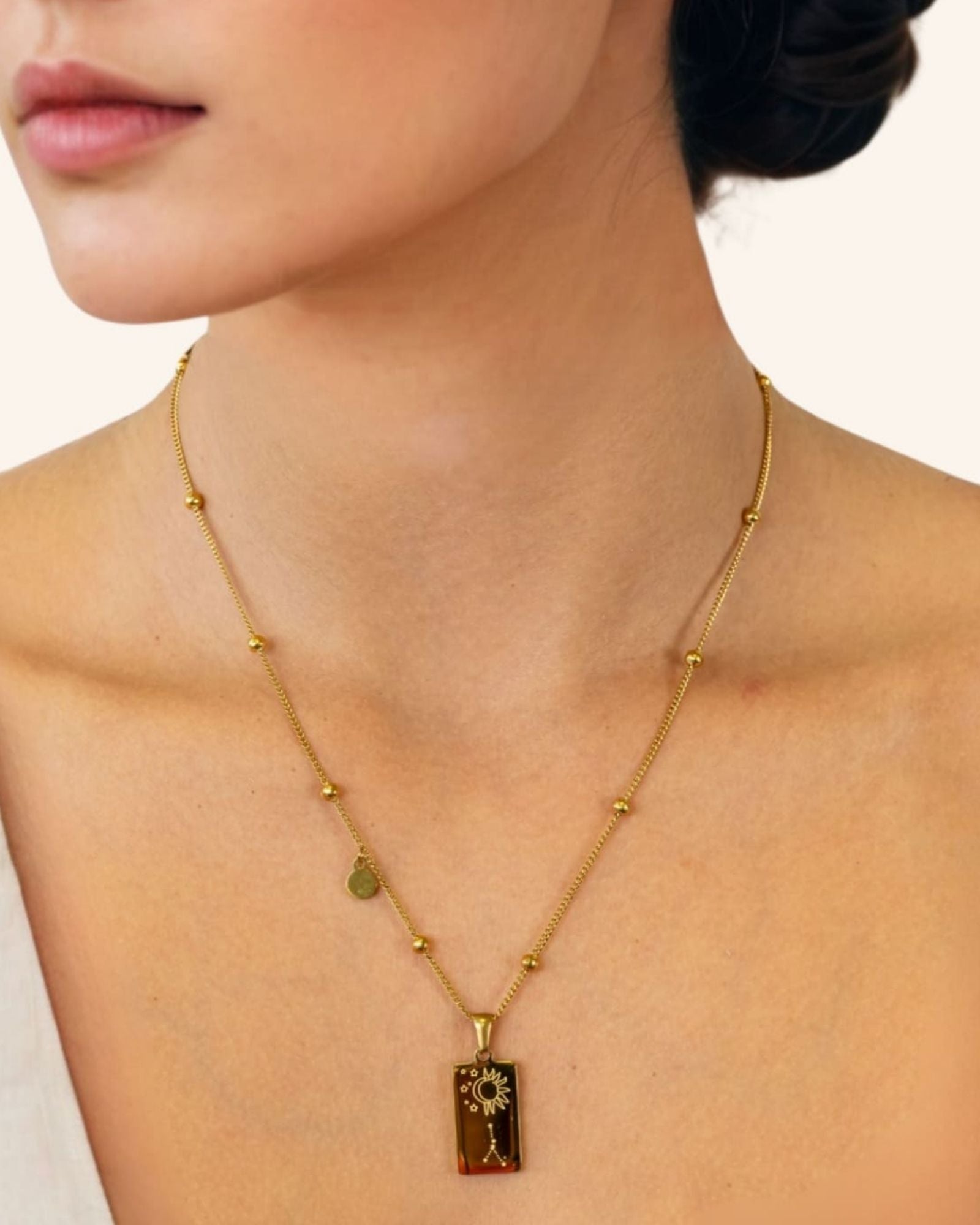 Cancer Gold Zodiac Tag Necklace by Lavana, on model engraved tag with constellation on beaded chain, back