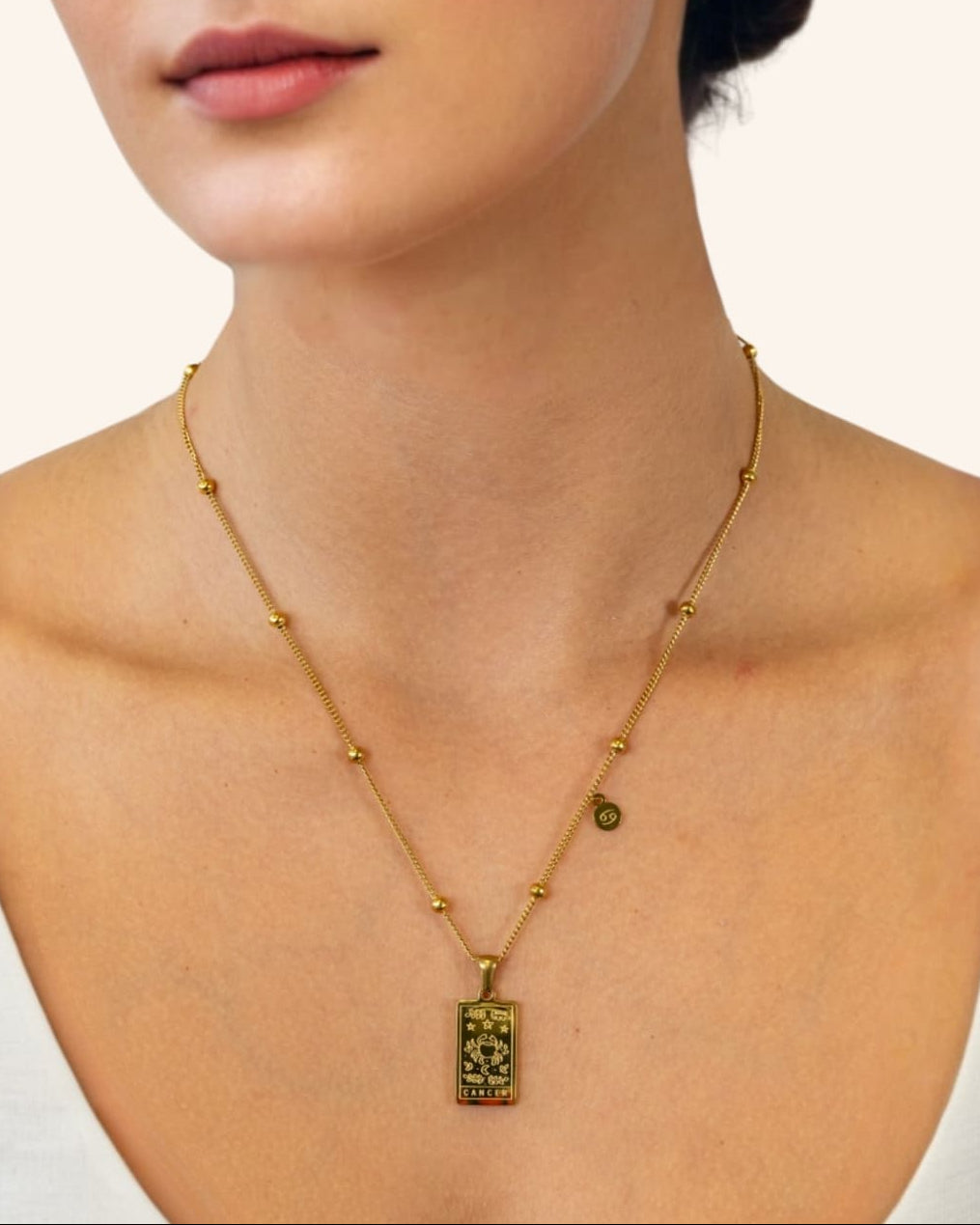 Cancer Gold Zodiac Tag Necklace by Lavana, on model engraved tag with constellation on beaded front