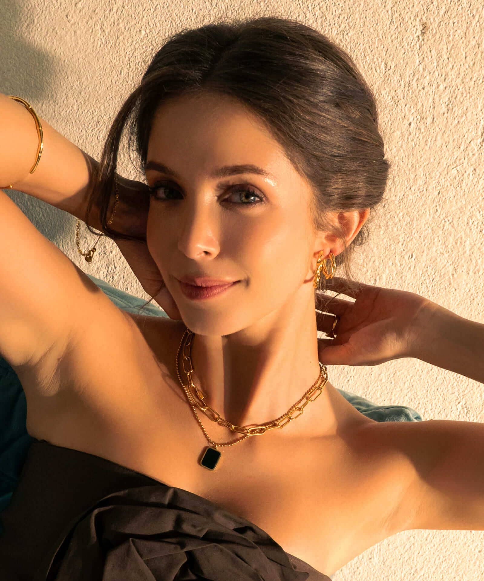 Cascade Gold Hoop Earrings by LAVANA, on model; overlapping arc design with polished finish dress hoops