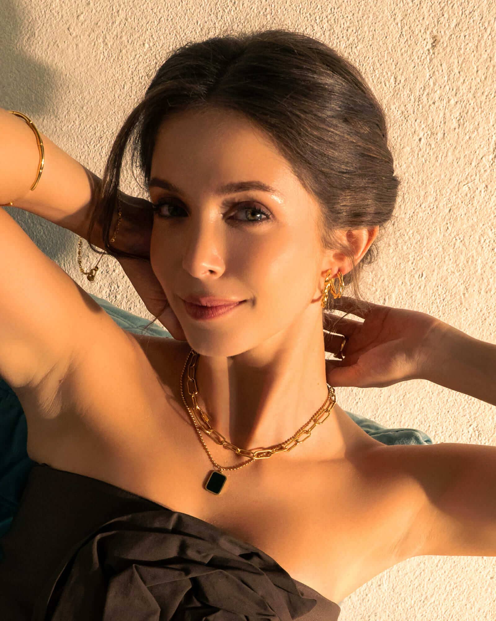 Cascade Gold Hoop Earrings by LAVANA, on model; overlapping arc design with polished finish dress hoops