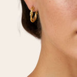 Cascade Gold Hoop Earrings by Lavana on model overlapping arc design with polished finish