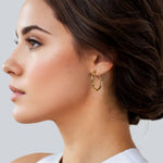 Dance Gold Hoop Earrings Large by Lavana on model slim ribbon twist hoop with polished finish