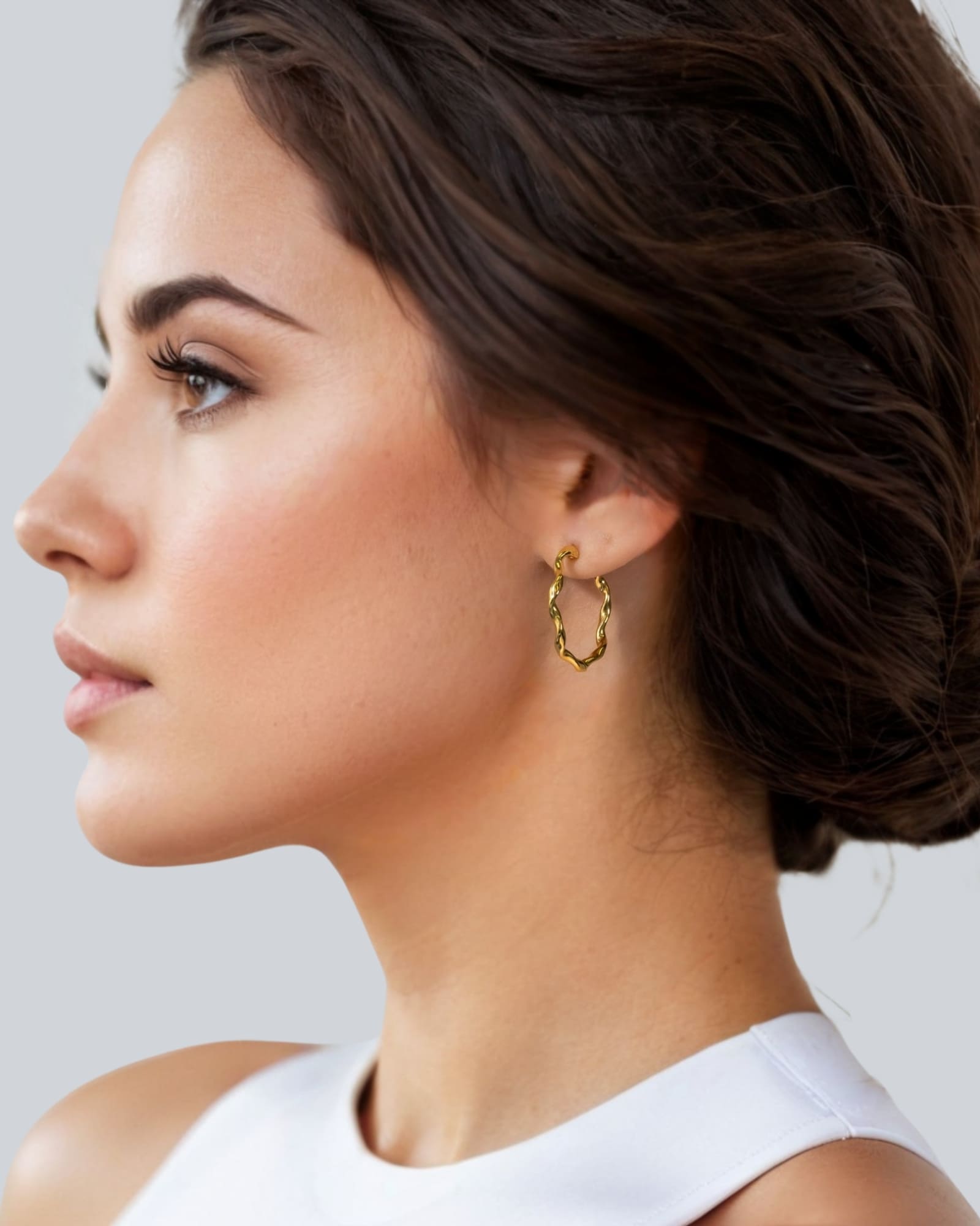 Dance Gold Hoop Earrings Large by Lavana on model slim ribbon twist hoop with polished finish