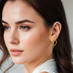 Dance Gold Hoop Earrings Medium and Large by Lavana on model slim ribbon twist hoop with polished finish
