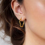 Dance Gold Hoop Earrings Medium by Lavana on model slim ribbon twist hoop with polished finish