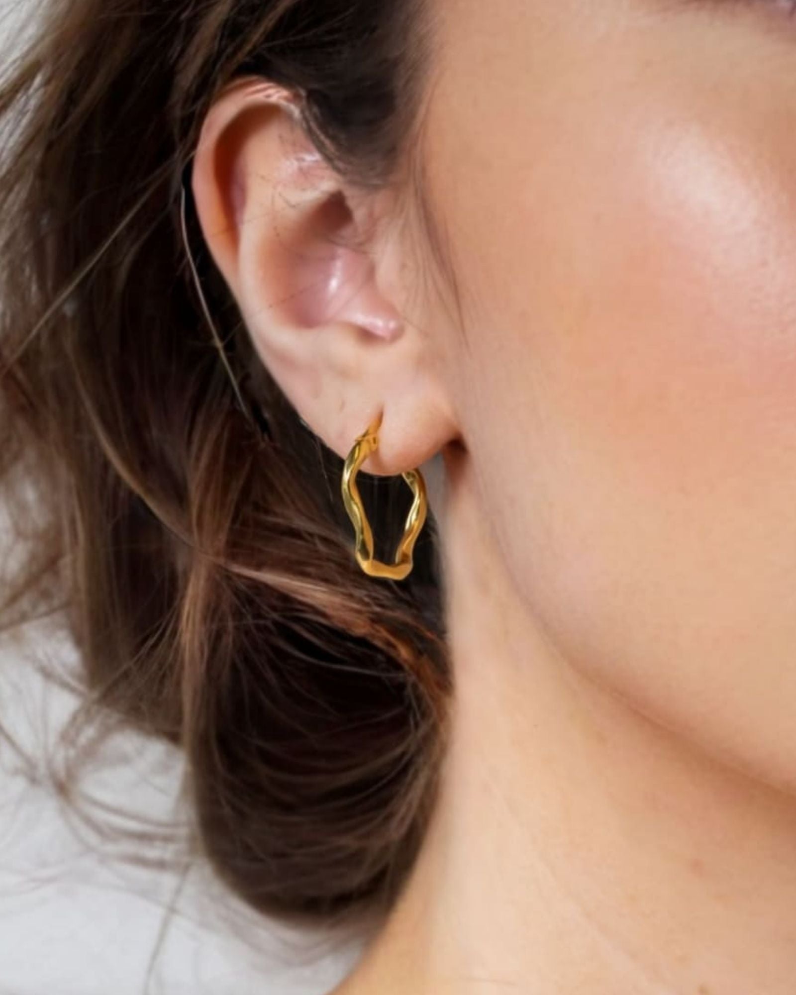 Dance Gold Hoop Earrings Medium by Lavana on model slim ribbon twist hoop with polished finish