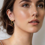 Dance Gold Hoop Earrings Medium by Lavana on model slim ribbon twist hoop with polished finish