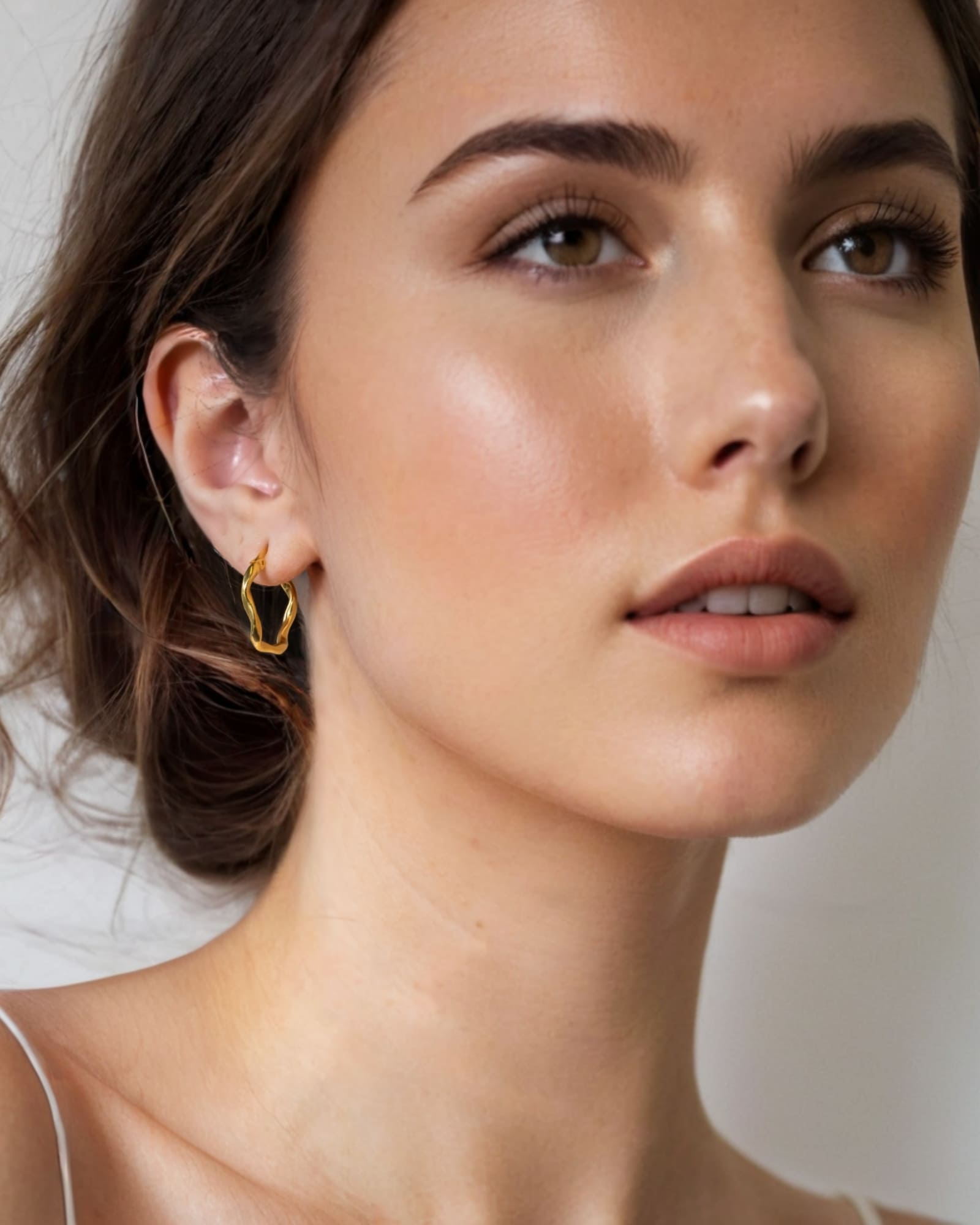 Dance Gold Hoop Earrings Medium by Lavana on model slim ribbon twist hoop with polished finish