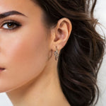 Dance Silver Hoop Earrings Large by Lavana on model slim ribbon twist hoop with polished finish