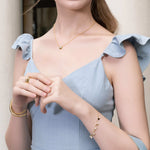 Dancing Discs Tango Gold Bracelet by Lavana, on model; chain bracelet with classic discs and freshwater pearl charms