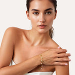 Dancing Discs Tango Gold Bracelet by Lavana, on model; chain bracelet with discs and freshwater pearl charms