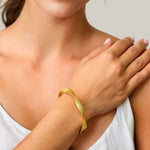 Disco Mesh Gold Cuff Bracelet by LAVANA on model twisty mesh surface with polished finish