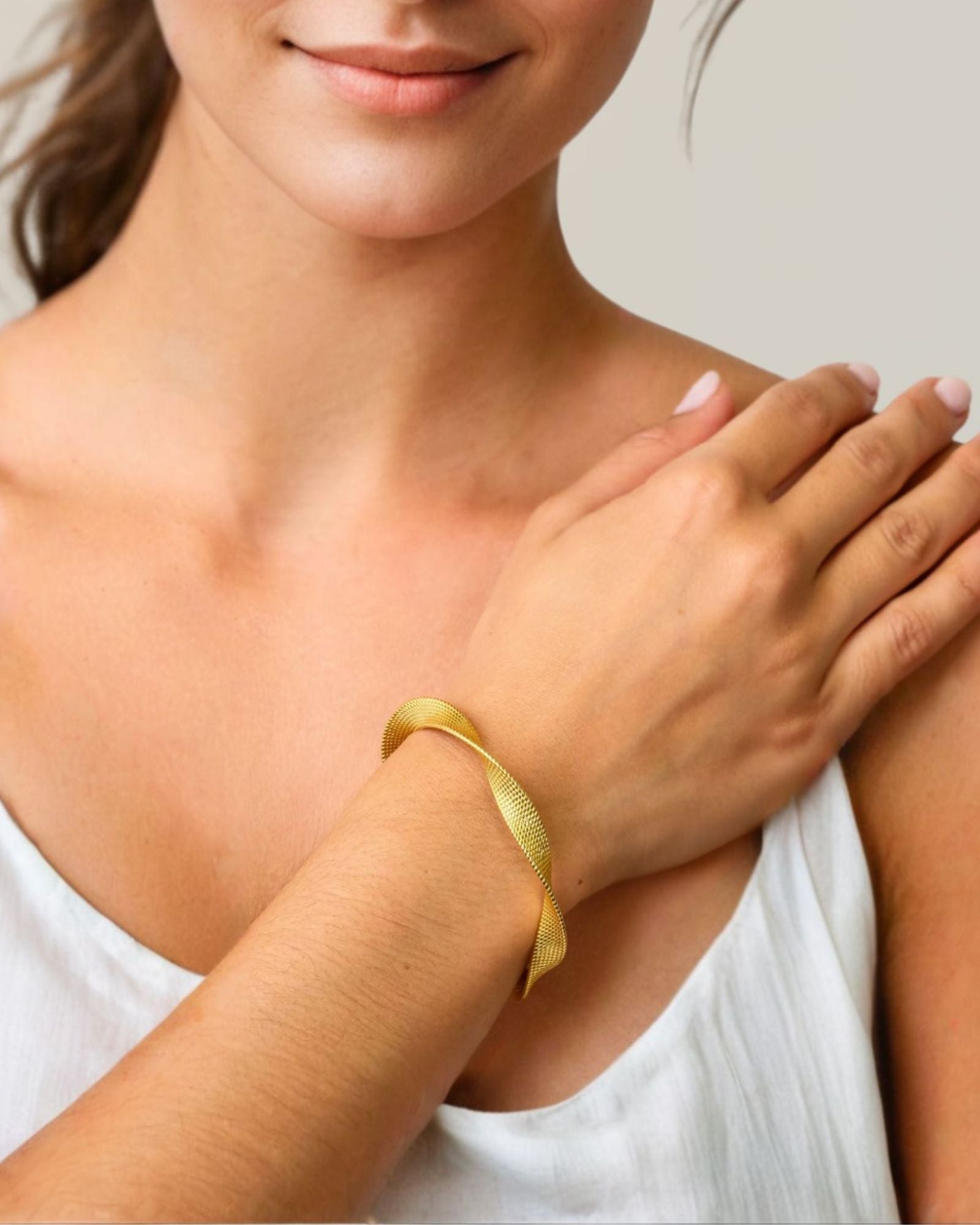 Disco Mesh Gold Cuff Bracelet by LAVANA on model twisty mesh surface with polished finish