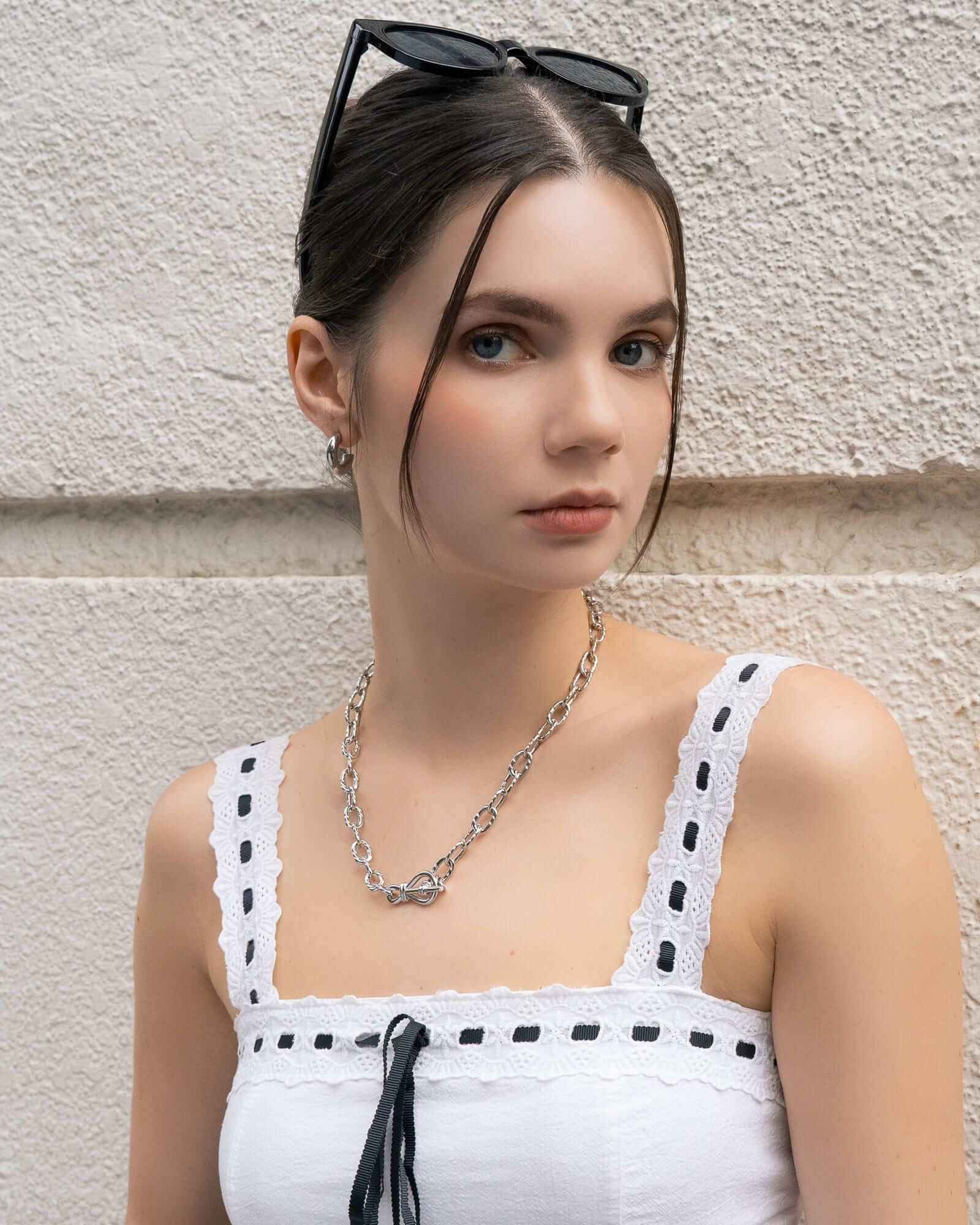 Dome Hoop Silver Huggie Earrings by LAVANA, on model; with smooth dome shine and close fit dress hoops