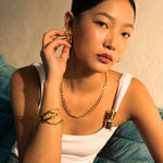 Drift Gold Hoop Earrings by LAVANA, on model; wide polished dress hoops with deep groove texture