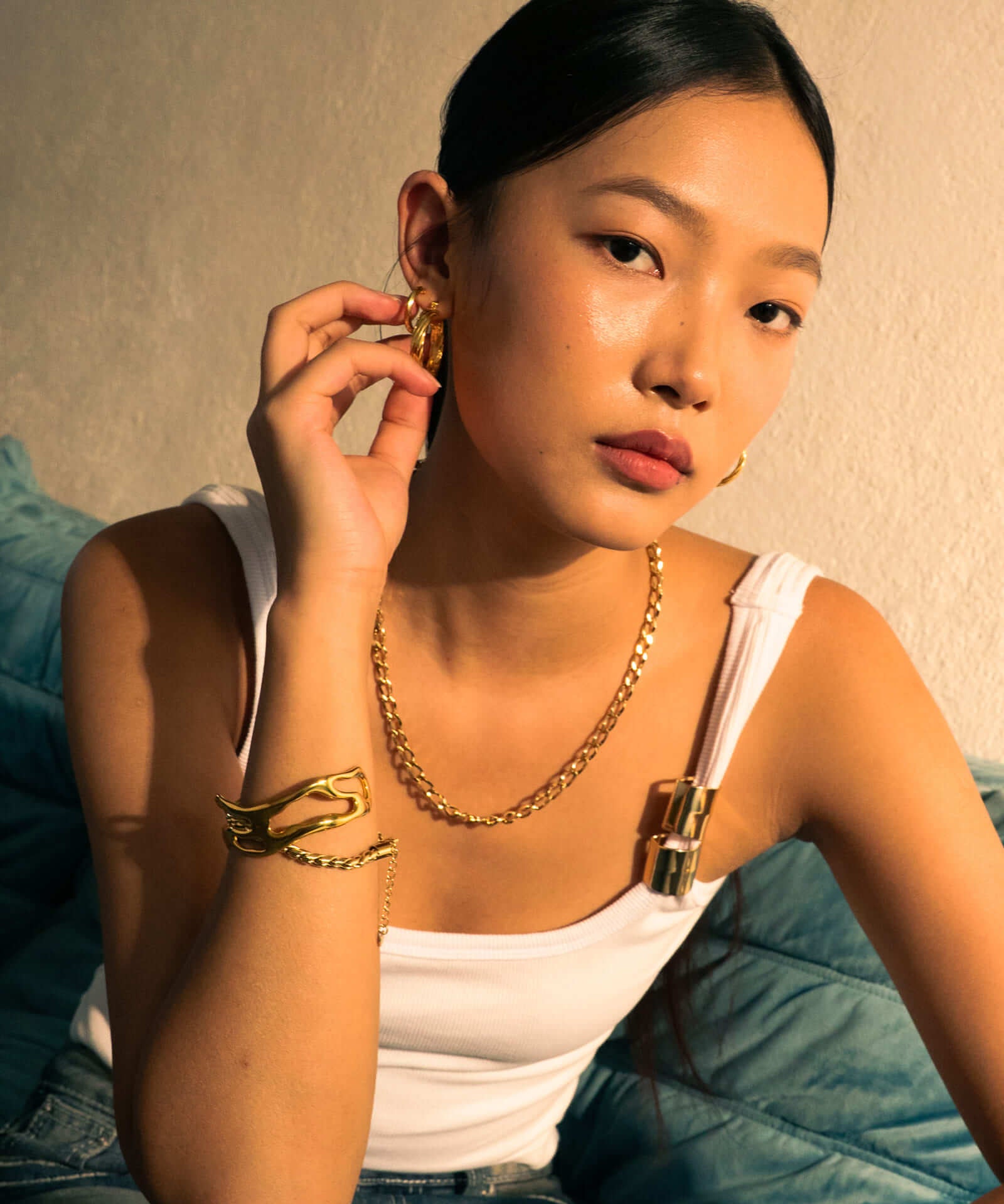 Drift Gold Hoop Earrings by LAVANA, on model; wide polished dress hoops with deep groove texture