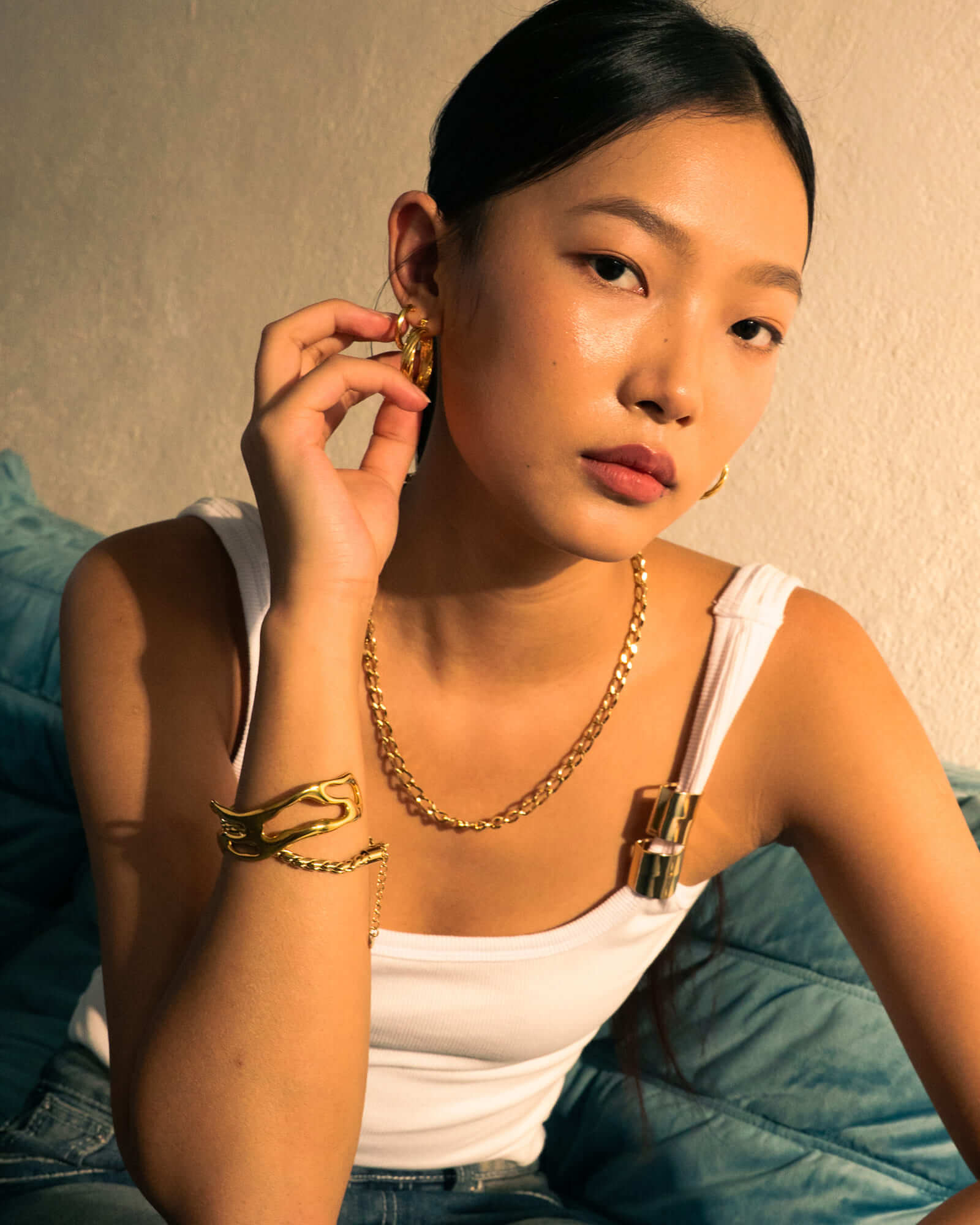 Drift Gold Hoop Earrings by LAVANA, on model; wide polished dress hoops with deep groove texture