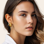 Ellipse Gold Hoop Earrings by Lavana, on model; slim oblong hinged hoops