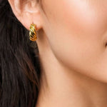 Eve Twist Gold Hoop Earrings by LAVANA on model compact huggie hoop with intertwined twist