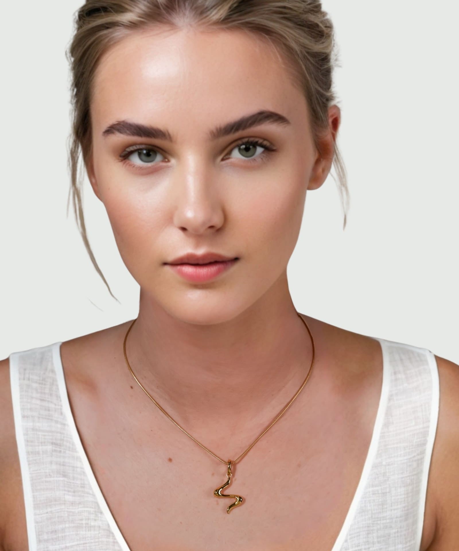 Fluid Gold Pendant by Lavana on model with sculptural wave silhouette