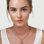 Fluid Gold Pendant by Lavana on model with sculptural wave silhouette