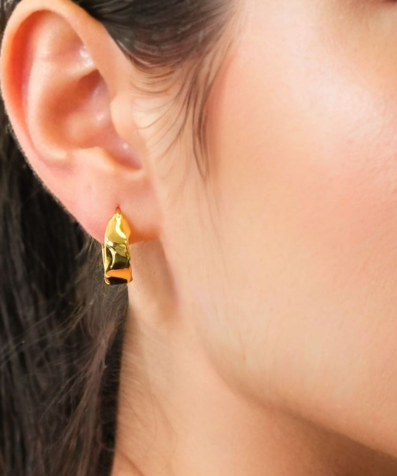 Fluidity Gold Hoop Earrings by LAVANA on model with polished organic ripple