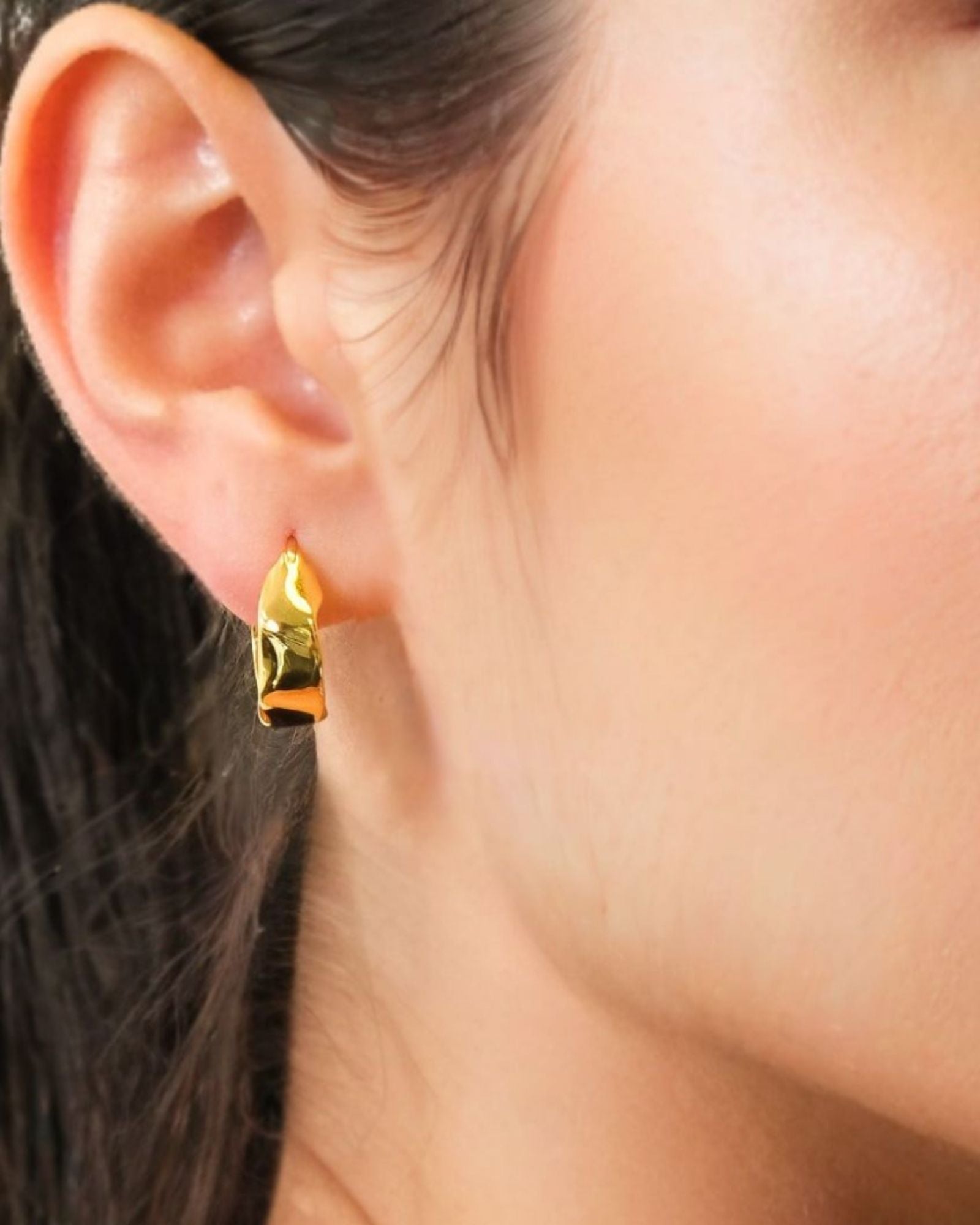 Fluidity Gold Hoop Earrings by LAVANA on model with polished organic ripple