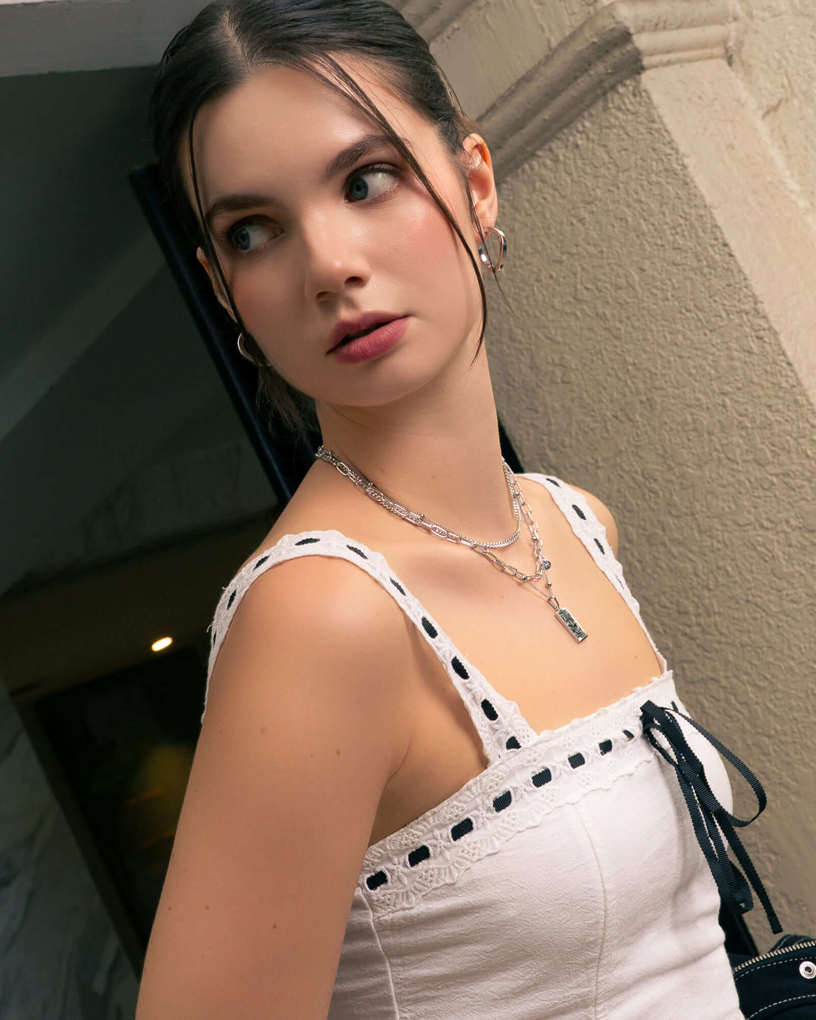 Formation Silver Hoop Earrings by LAVANA, on model; sculpted dress hoops  with subtle textured shape