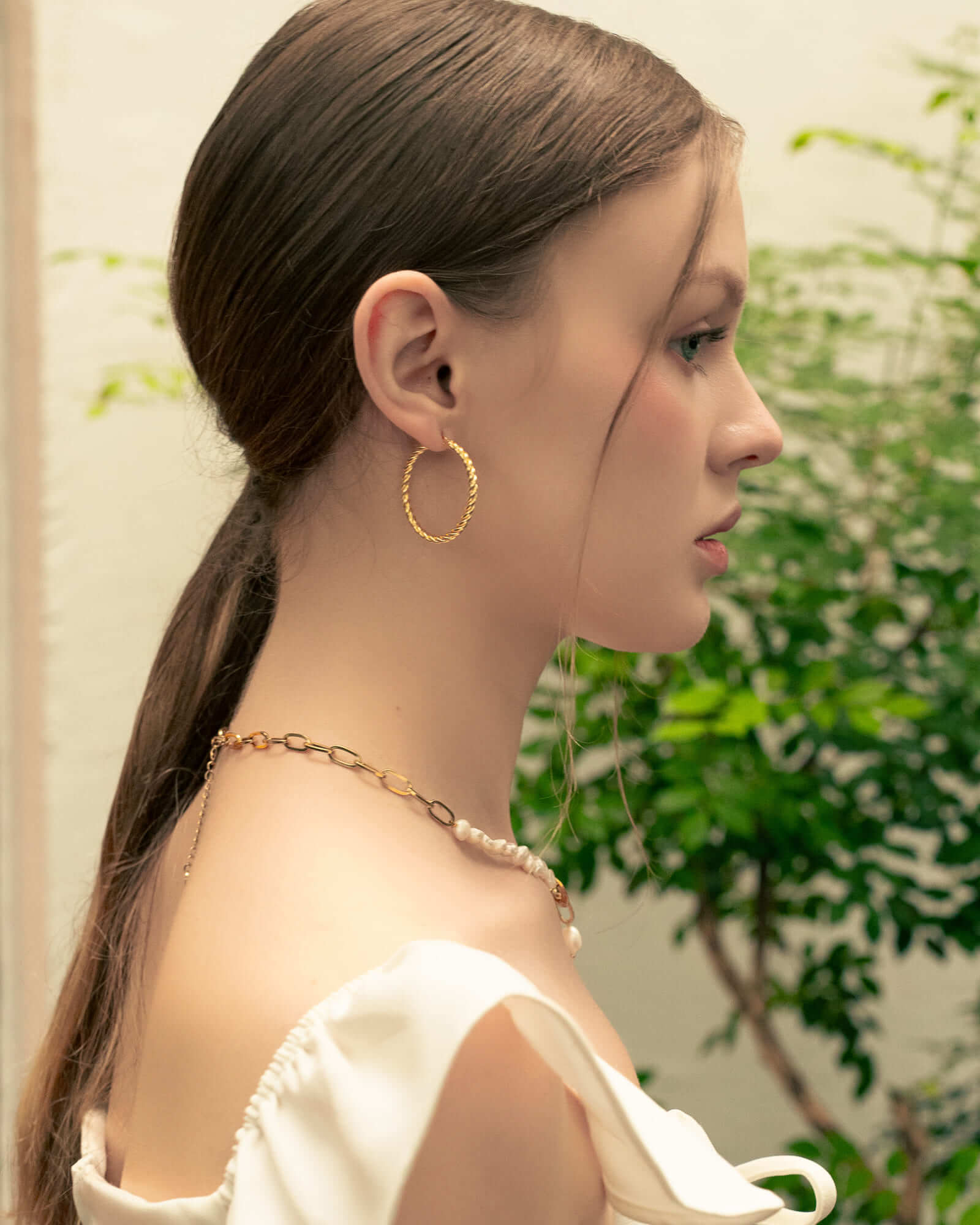 Grace Gold Hoop Earrings by LAVANA, on model; large lightweight dress hoops with diagonal grooves