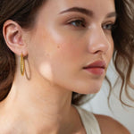 Grace Gold Hoop Earrings by Lavana on model large lightweight hoops with diagonal grooves