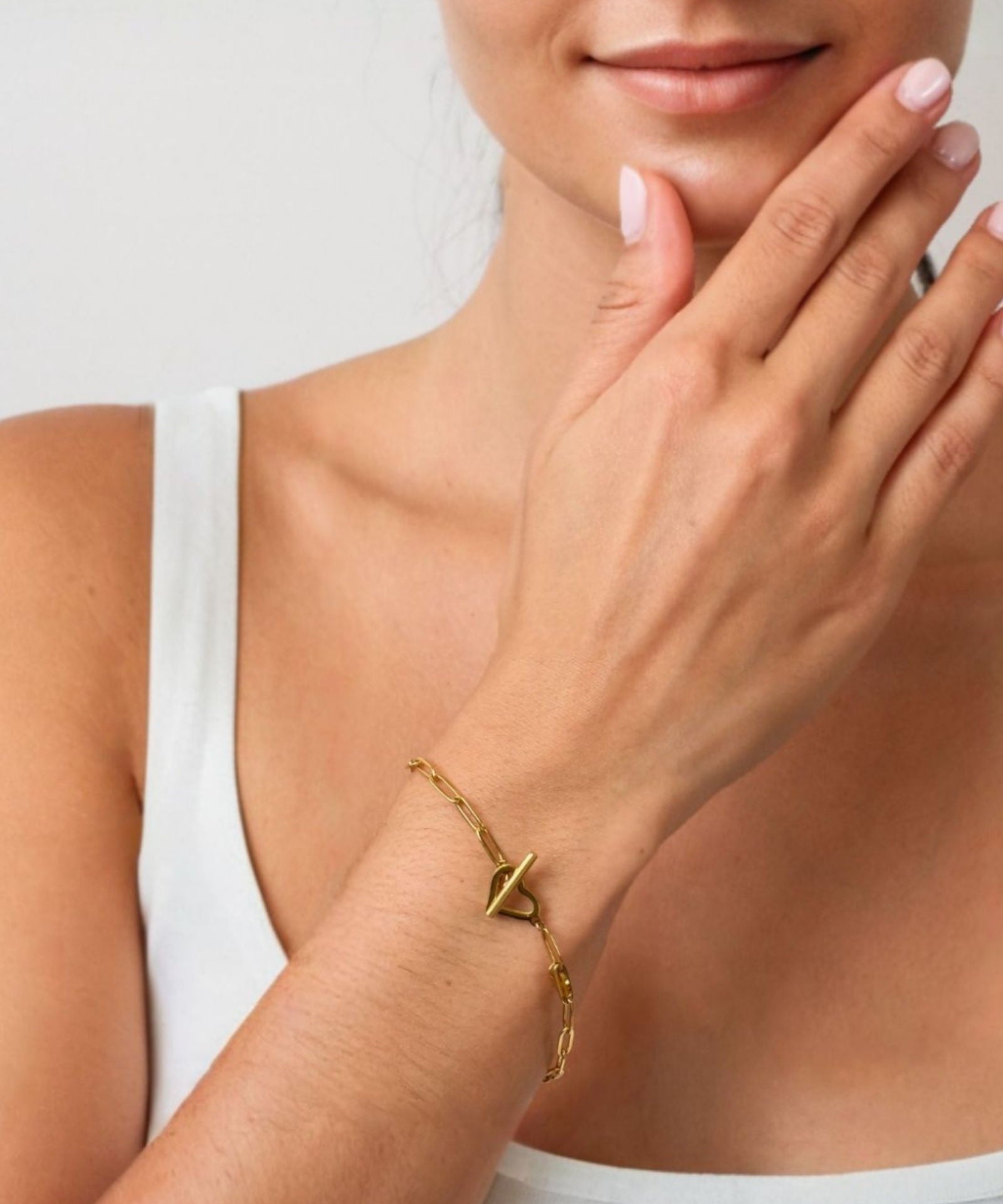 Heartlock Gold Paperclip Bracelet by LAVANA on model paperclip links with front heart T bar toggle