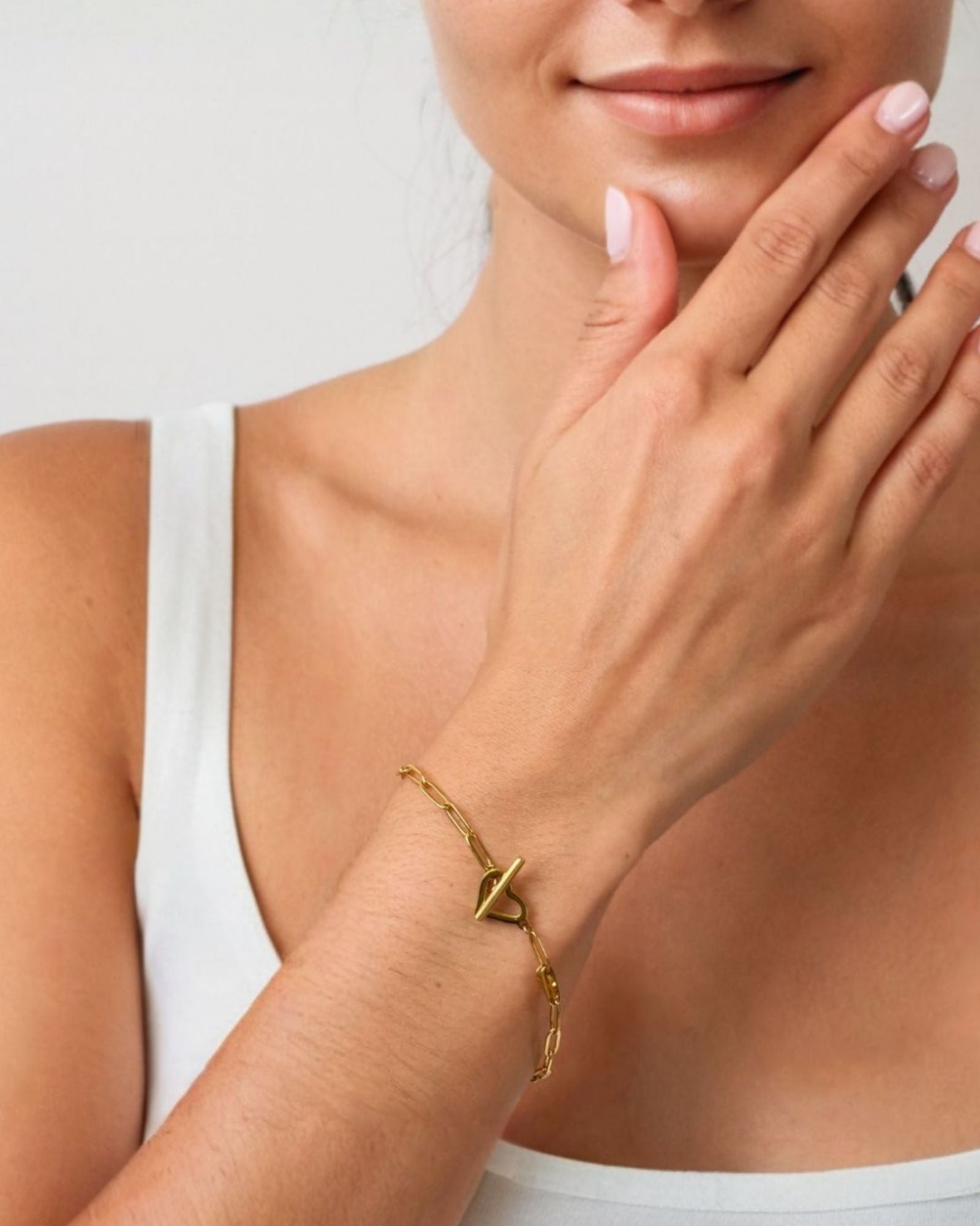 Heartlock Gold Paperclip Bracelet by LAVANA on model paperclip links with front heart T bar toggle