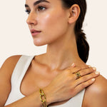 Infinity Link Gold Cuff Bracelet by Lavana on model with central interlocking link and polished finish