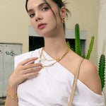 Latch Link Gold Charm Necklace by Lavana, on model; modern paperclip chain with five openable charm links