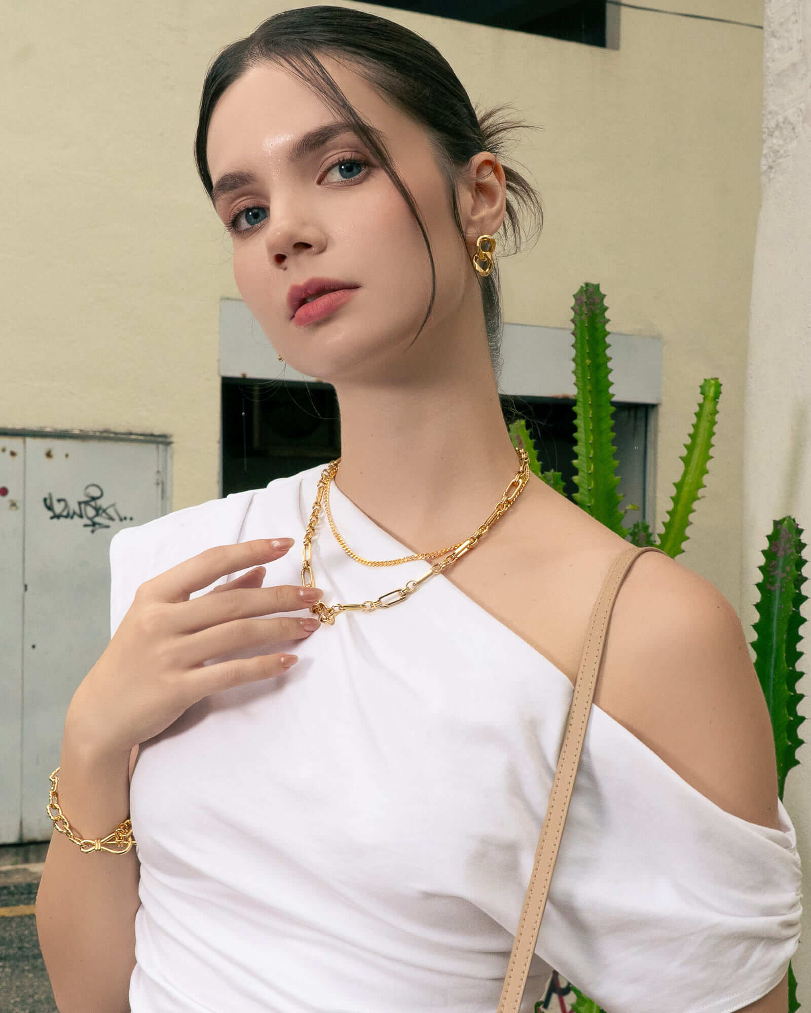 Latch Link Gold Charm Necklace by Lavana, on model; modern paperclip chain with five openable charm links