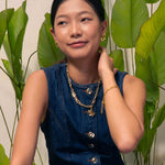 Latch Link Gold Necklace by Lavana, on model; paperclip chain five charm links Fluid pendant sculptural wave silho